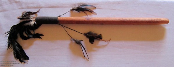 Voodoo pointer made of wood with feathers